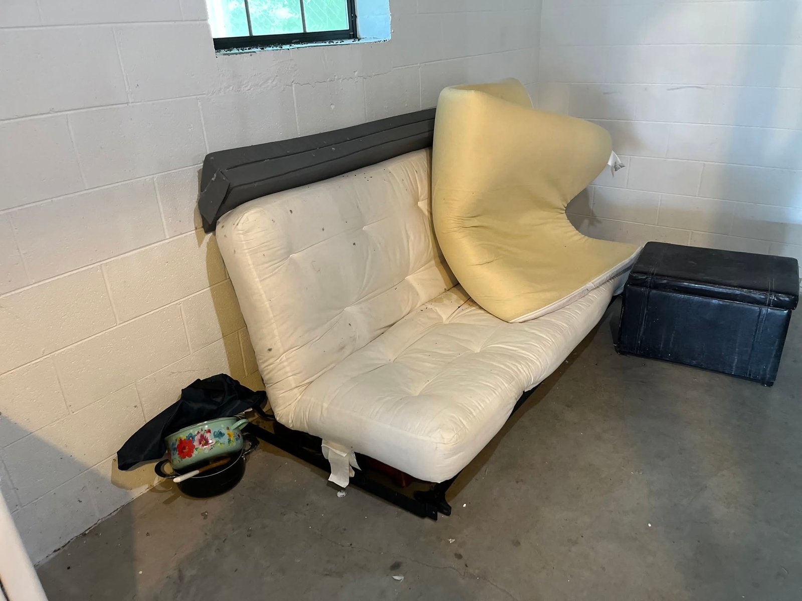 Professional sofa removal team in Spokane WA hauling a couch out of a home